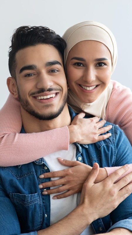 A smiling couple showing healthy teeth